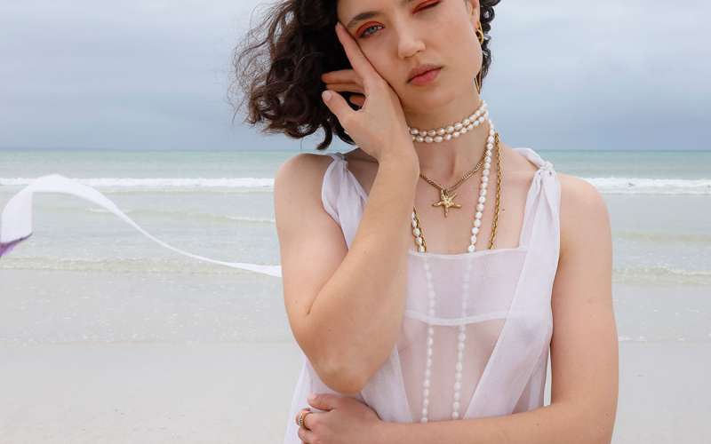 Wanda on the beach wearing sheer clothing